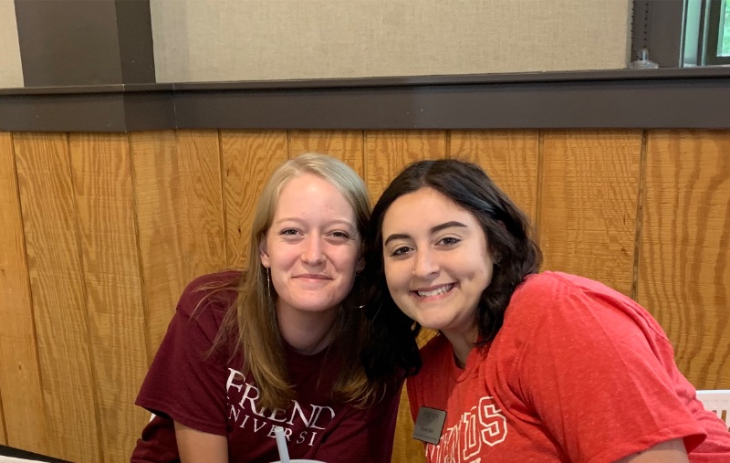 Friends University graduate students help with registration for graduate credit.