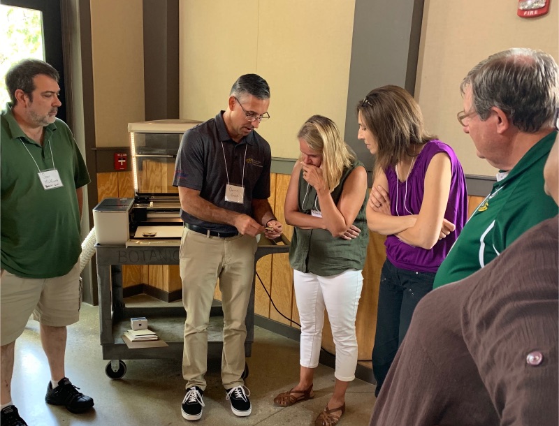 Darren Couch, AP Computer Science, Engineering, Robotics Teachers, The Independent School of Wichita, explains what his portable laser machine can make in his Thursday afternoon breakout.